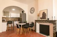 a kitchen and dining room with a table and a fireplace at Lumineux T5 - Climatisation in Perpignan
