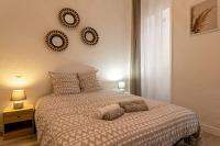 a bedroom with a bed and two plates on the wall at Lumineux T5 - Climatisation in Perpignan