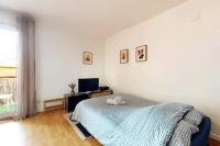 a bedroom with a bed and a desk and a television at Chaleureux et Cosy proche Gare in Massy