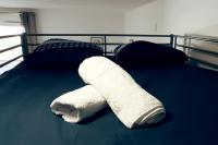 a wrapped up white towel on a bed at Chaleureux et Cosy proche Gare in Massy
