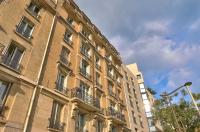 a large brick building with balconies and a street light at GuestReady - Beautiful Apt near Paris Zoo in Paris