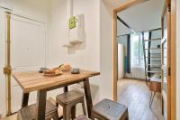 a small kitchen with a wooden table and stools at GuestReady - Beautiful Apt near Paris Zoo in Paris