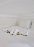 a white bed with towels and pillows on it at GuestReady - Beautiful Apt near Paris Zoo in Paris