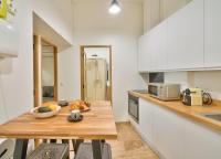 a kitchen with a table with a bowl of fruit on it at GuestReady - Beautiful Apt near Paris Zoo in Paris
