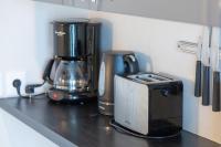 a kitchen counter with a coffee maker and a toaster at Appartement vue mer - 200m plage in Concarneau