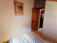 a bedroom with a bed and a picture on the wall at Appartement Le Grand-Bornand, 3 pièces, 6 personnes - FR-1-241-61 in Le Grand-Bornand