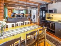 a kitchen and dining room with a table and chairs at Holiday Home Tiira by Interhome in Himahuuha