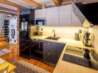 a kitchen with a sink and a black refrigerator at Holiday Home Tiira by Interhome in Himahuuha