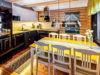 a kitchen with a dining table and chairs at Holiday Home Tiira by Interhome in Himahuuha