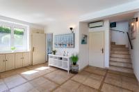 a home with a staircase and a hallway with a sink at VILLA COTE SUD VI4402 By Riviera Holiday Homes in Cagnes-sur-Mer