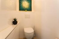 a bathroom with a toilet and a picture on the wall at VILLA COTE SUD VI4402 By Riviera Holiday Homes in Cagnes-sur-Mer