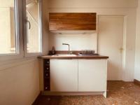 a small kitchen with a sink and a window at La brocante sur la seine -309 in Rouen