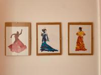 four framed pictures of women on a wall at La brocante sur la seine -309 in Rouen