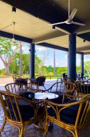 un groupe de chaises et de tables sur une terrasse dans l'établissement Cinta Sayang Resort, à Sungai Petani