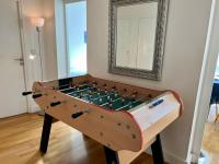 a foosball table in a living room with a mirror at Bienvenue in Montrouge