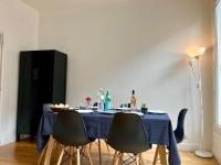 a table with chairs and a blue table cloth on it at Bienvenue in Montrouge