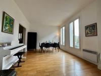 a living room with a piano and a table with chairs at Bienvenue in Montrouge