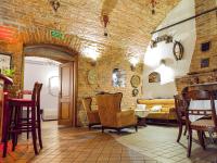 een kamer met een bakstenen muur met stoelen en een tafel bij Hotel Restauracja Rondo in Kutno