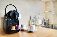 a tea kettle on a kitchen counter next to a sink at Comfy Suite by Les Maisons de Charloc Homes in Boulogne-Billancourt