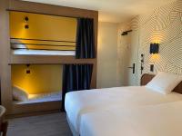 a hotel room with two bunk beds in it at Bijou Hôtel Paris Boulogne in Boulogne-Billancourt