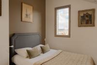 a bed in a bedroom with a window at Studio et appartements Sainte Catherine in Honfleur