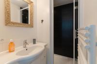 a bathroom with a sink and a mirror and a shower at Studio et appartements Sainte Catherine in Honfleur