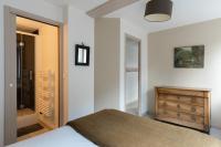 a bedroom with a bed and a dresser and a mirror at Studio et appartements Sainte Catherine in Honfleur