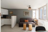 a living room with a couch and a kitchen at Studio et appartements Sainte Catherine in Honfleur
