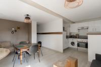 a kitchen and living room with a table and chairs at Studio et appartements Sainte Catherine in Honfleur