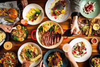 a group of people sitting around a table with plates of food at Hilton Quebec in Quebec City