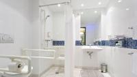 a white bathroom with a sink and a shower at Holiday Inn Express Singen, an IHG Hotel in Singen