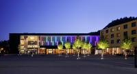 a building with trees in front of it at night at Holiday Inn Express Singen, an IHG Hotel in Singen