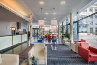 an office lobby with red chairs and tables at Holiday Inn Express Singen, an IHG Hotel in Singen