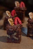 a piece of chocolate cake with strawberries on top at Can Jaume by Ocean Drive in Ibiza Town