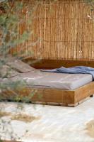 a bed in a room with a bamboo wall at Can Jaume by Ocean Drive in Ibiza Town