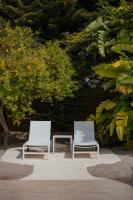 two white chairs and a table in front of a tree at Can Jaume by Ocean Drive in Ibiza Town
