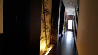 a hallway with a long hallway with a wall with plants on it at Yang Home Stay in Ruisui