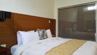 a bedroom with a large bed with a wooden headboard at Yang Home Stay in Ruisui