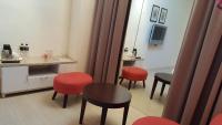 a room with red chairs and a table and a mirror at Yang Home Stay in Ruisui