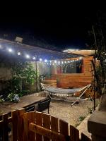 an outdoor patio with lights on a cabin at night at La Casetta in Gattières