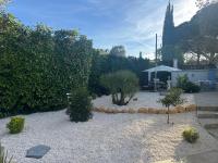 a backyard with a garden with trees and a patio at Central Valbonne Villa in Valbonne