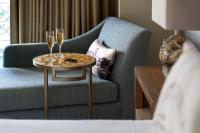 a table with two champagne glasses on it next to a couch at The Ritz-Carlton, Sarasota in Sarasota