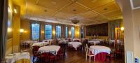 a dining room with white tables and chairs at Grand Hotel De Londres in Sanremo
