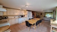 a kitchen and dining room with a table and chairs at Les Bigoussies in Ribérac