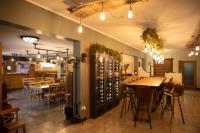 a restaurant with tables and chairs and a wine cellar at Camping Fuussekaul in Heiderscheid