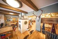 a kitchen and dining room with a table and chairs at Camping Fuussekaul in Heiderscheid
