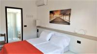 A bed or beds in a room at Hotel Ciao Bed & Breakfast