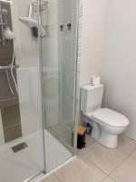 a bathroom with a toilet and a glass shower at Bel appartement avec vue sur la Baie d&#39;Authie in Berck-sur-Mer