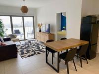 a kitchen and living room with a table and chairs at Bel appartement avec vue sur la Baie d&#39;Authie in Berck-sur-Mer