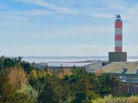 a red and white lighthouse on top of a building at Bel appartement avec vue sur la Baie d&#39;Authie in Berck-sur-Mer